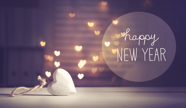 Happy New Year message with a white heart with heart shaped lights