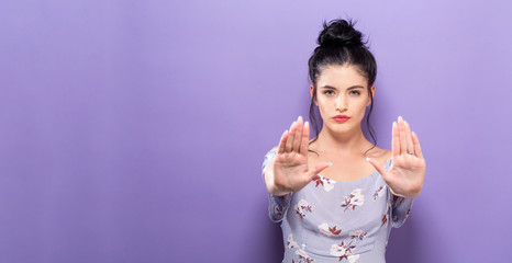 Young woman making a rejection pose a solid background
