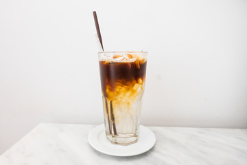ice coffee drink in glass on the table with white background.
