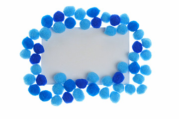 Pompon Mockup.  rectangular frame of bright dark blue and blue little woolen pompoms  isolated on white background. Winter Mock up. copy space