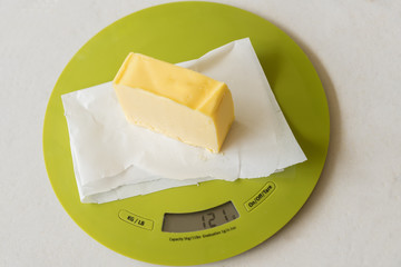 Wedge of butter on kitchen scale