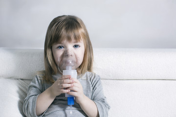 Little girl making inhalation with nebulizer at home. child asthma inhaler inhalation nebulizer steam sick cough concept - obrazy, fototapety, plakaty