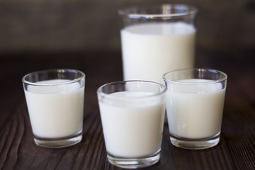 rustic dairy products, glass of milk on a wooden table