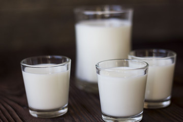rustic dairy products, glass of milk on a wooden table