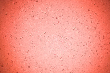 Rain droplets on red glass background, Water drops on glass.