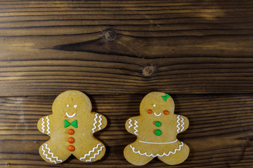 Christmas gingerbread couple cookies on wooden table. Top view