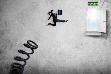 Female manager jumping toward success door