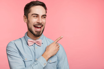 People and advertising concept. Good looking young unshaven male wears festive clothes as...