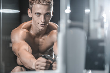 Fototapeta na wymiar Handsome model young man training back in gym