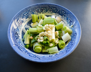 Chopped leeks and garlic in a blue dish