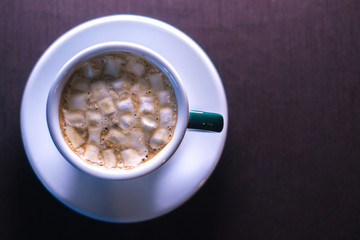 Coffee in cafe with marshmallow with blurred background.
