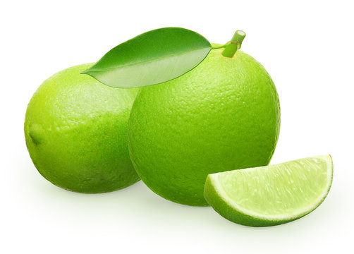 Lime fruit with green leaf next to lying and slice