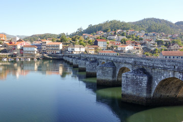 Fototapeta na wymiar Old stone bridge ancient city bay sunny day blue sky