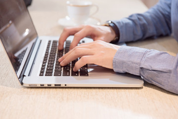 close up hand of businessman use keyboard on laptop.