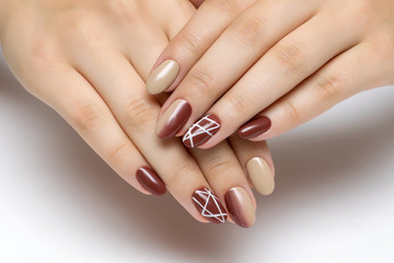 beige brown manicure with ombre and white stripes on long oval nails
