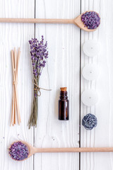 Aromatherapy for relax concept. Lavender branch, spa salt, oil and candles on white background top view