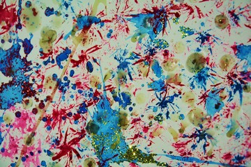 Sparkling lights, paint and watercolor background in red, blue, green, yellow hues and colors