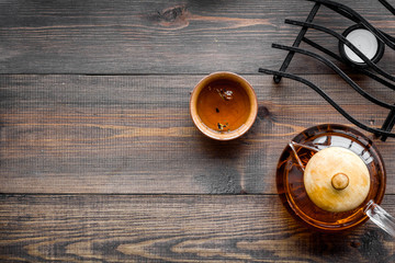 Tea break. Cookware fo tea ceremony. Tea pot and cups on dark wooden background top view copyspace