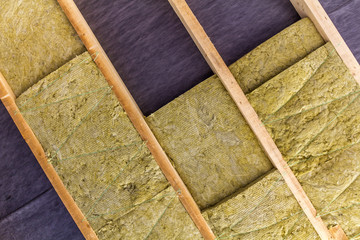 Thermal insulation mineral rock wool installation at the new building attic ceiling