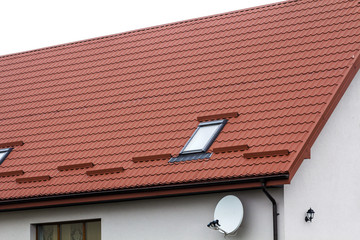 Roof of a new house made from red roofing tiles