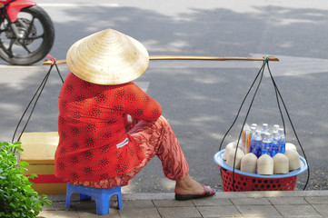 Street vendor selling coconuts in Saigon