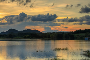Obraz na płótnie Canvas Beautiful sunset on lake in the hill.