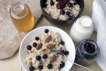 Delicious oatmeal porridge with berry and almonds for breakfast.