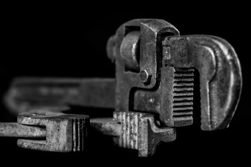 Rusty, old workshop keys. Hydraulic keys on a black table in a workshop. Black background.