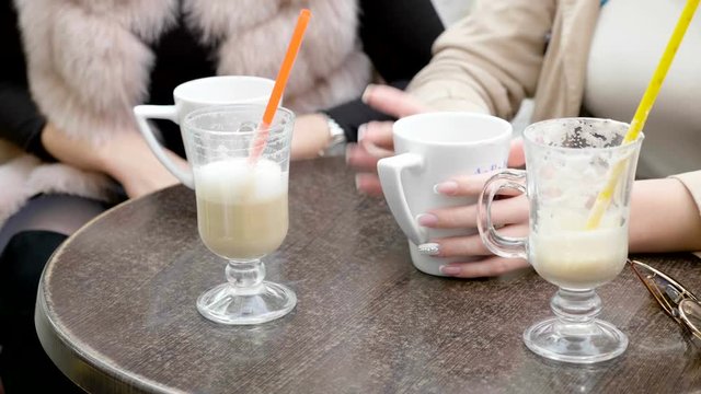 Close up on cafe table with coffee drinks. Friends hanging out