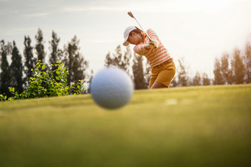 Motion blur golfers hit sweeping and keep golf course in the summer for relax time