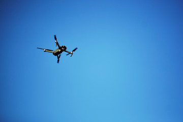 Flying drone with blue sky background