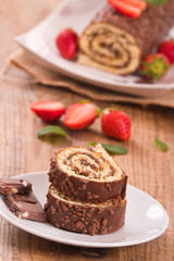 Chocolate roll with hazelnuts and strawberries. 