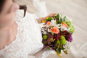 beautiful wedding bouquet with roses in bride's hands.