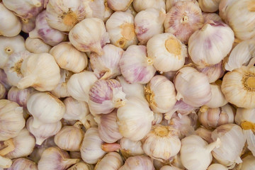 A pile of garlic in supermarket as background, texture