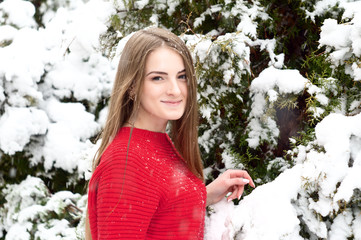 Very beautiful girl in a red sweater in the park