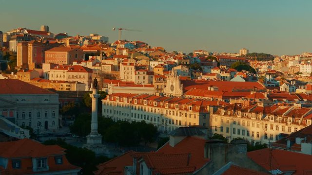 Telephoto shot revealing the Praca D. Pedro IV square, also known as Rossio square, in Lisbon, Portugal during daytime on a sunny day