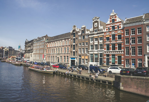 Traditional old buildings and boats in Amsterdam, Netherlands. Canals of Amsterdam.