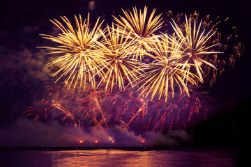 holiday fireworks of golden color on a black sky background