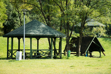 Leisure gazebo in the forest and garden. Season of autumn.