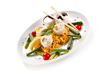 Roast, stuffed chicken roulade with rice and vegetables on white background 