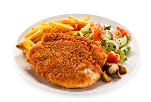     Fried pork chop, French fries and vegetables 