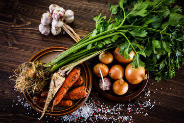 Raw vegetables on wooden background 