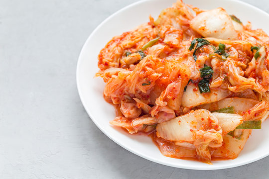 Kimchi cabbage. Korean appetizer on white plate, horizontal, copy space