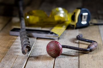 Old good carpentry, tools drill bit. Wooden carpentry table and old good carpentry tools on it.