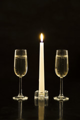 Outline of glasses of champagne and the candle