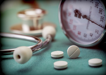White pad next to a manometer to measure blood pressure and a stethoscope in a hospital, conceptual...