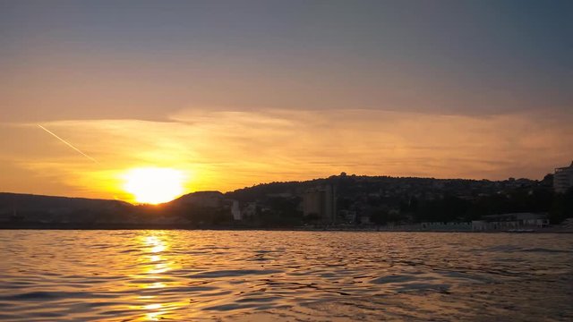 Time lapse of the sunset scenery on Black sea coast, view on Balchik city in Bulgaria.