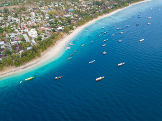 Aerial view of Gili Trawangan Island coastline with boats and buildings, West Nusa Tenggara, Indonesia