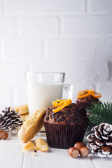 Freshly baked homemade chocolate muffins with jug with milk