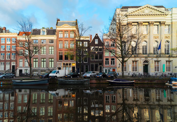 Facades of historic dutch houses over canal with mirror reflections, Amstardam, Netherlands, retro toned